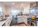 Bright kitchen featuring white cabinets, marble countertops, and stainless steel appliances at 2405 Hillside Ave, Decatur, GA 30032