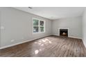 Sun-filled living room with hardwood floors and a fireplace at 3919 Valley Brook Rd, Snellville, GA 30039
