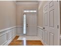 Bright entryway featuring hardwood floors, white trim, and natural light at 1102 Lexington Dr, Roswell, GA 30075
