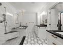 Elegant bathroom showcasing marble accents, patterned floors, dual vanity, and walk-in shower with seating at 3330 Overland Dr, Roswell, GA 30075