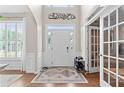 Bright foyer with hardwood floors, white wainscoting, decorative rug, and lots of natural light at 530 Camber Woods Dr, Roswell, GA 30076
