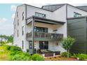 Stylish rear balcony with outdoor seating and jacuzzi tub, perfect for relaxation at 6895 Whitman Walk, Alpharetta, GA 30005