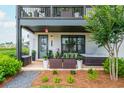 Inviting front porch featuring a hot tub and cozy seating area with a Welcome sign at 6895 Whitman Walk, Alpharetta, GA 30005