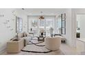 Comfortable living room area with plush seating, large windows, and stylish decor at 775 Juniper St # 111, Atlanta, GA 30308