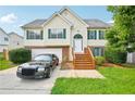Charming two-story home with green shutters, a well-manicured lawn, and a two-car garage at 1147 Saint Phillips Ct, Locust Grove, GA 30248
