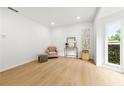 Bright living room featuring wood floors, recessed lights, a large window and contemporary decor at 3684 Clearbrooke Way, Duluth, GA 30097