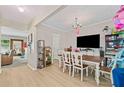 Open concept dining room with wood floors, bright chandelier, and an open floorplan at 4161 Magnolia Glen Walk, Norcross, GA 30093