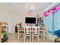 Inviting dining room with wood floors, chandelier, and large window with lots of natural light at 4161 Magnolia Glen Walk, Norcross, GA 30093