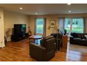 Spacious living room with hardwood floors, cozy seating, and abundant natural light from large windows at 4323 Darwen Ct, Tucker, GA 30084