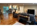 Open-concept living area featuring hardwood floors, leather furniture, and a kitchen with modern appliances at 4323 Darwen Ct, Tucker, GA 30084