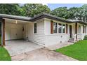 Home with a covered parking area, white siding, and charming wood shutters at 629 Dunton Se Cir, Smyrna, GA 30082