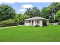 Charming single-story home featuring white siding, a well-manicured lawn, and a covered carport on a tree-lined street at 629 Dunton Se Cir, Smyrna, GA 30082