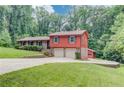Two-story home with a front-facing, two-car garage and extended driveway on landscaped lot at 1148 Woodland Cir, Lawrenceville, GA 30043