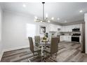 Modern dining area with contemporary light fixture next to an updated kitchen space at 872 Beryl Sw St, Atlanta, GA 30310