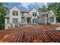 Spacious home with stone and brick exterior, large windows, and professionally prepped landscaping at 120 Wood River Ct, Johns Creek, GA 30097