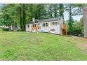 Home exterior featuring a well-manicured lawn and a deck with wooden railings at 1995 Venetian Sw Dr, Atlanta, GA 30311