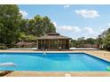 Resort style backyard with a pool, gazebo, and a covered area for relaxing at 202 Heights Pl, Canton, GA 30114