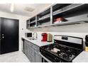 Modern kitchen with gray cabinets, stainless steel appliances, and a gas range at 215 Piedmont Ne Ave # 1109, Atlanta, GA 30308