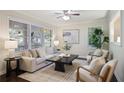 Bright living room with large windows, ceiling fan, hardwood floors and neutral decor offers a cozy space at 2383 Edgewater Sw Dr, Atlanta, GA 30311