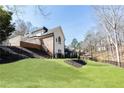 Expansive backyard with lush lawn, landscaping, and an outdoor entertaining area at 9360 Nesbit Lakes Dr, Alpharetta, GA 30022