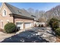 A spacious three-car garage and driveway provide ample parking at this lovely home at 9360 Nesbit Lakes Dr, Alpharetta, GA 30022
