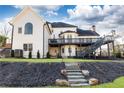 Stunning home with a large deck and a stone staircase leading to the backyard at 9360 Nesbit Lakes Dr, Alpharetta, GA 30022