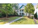 Beautiful two-story home featuring a well-manicured lawn and charming front porch, perfect for relaxing at 1922 Perry Nw Blvd, Atlanta, GA 30318