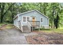 Charming bungalow with light blue siding, wood porch and stairs, and front yard at 2803 3Rd Sw Ave, Atlanta, GA 30315