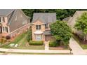 An aerial view of a brick house with manicured landscaping and a well-maintained lawn at 4084 Fort Sumter Nw Lndg, Acworth, GA 30101