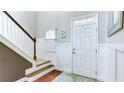 Bright foyer with staircase, white wainscoting, and hardwood floors at 4084 Fort Sumter Nw Lndg, Acworth, GA 30101