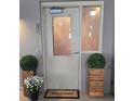 Condo entrance with 'Welcome' mat and potted plants at 855 Peachtree Ne St # 501, Atlanta, GA 30308