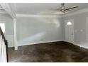 Spacious living room with hardwood floors, white walls, and a large front door at 1539 Beecher Sw St, Atlanta, GA 30310