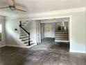 Open-concept living room featuring hardwood floors, modern lighting, and stairs to the second floor at 1539 Beecher Sw St, Atlanta, GA 30310