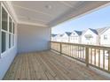 Spacious outdoor porch with wooden flooring and a view of neighboring homes at 1980 Deco Dr, Kennesaw, GA 30144