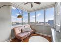 Sunroom with expansive windows offering city views, a comfortable couch and decorative shelving at 215 Piedmont Ne Ave # 1406, Atlanta, GA 30308