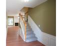 Inviting foyer featuring hardwood floors and carpeted stairs to upper level at 2426 Fairlie Dr, Duluth, GA 30096