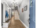 Inviting entryway with tiled floor, coat rack, and staircase featuring stylish chandelier at 1912 Hosea L Williams Ne Dr # 1, Atlanta, GA 30317