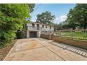Two-story home featuring a deck and a garage nestled in a green surrounding at 3422 Maplehurst Dr, Decatur, GA 30032