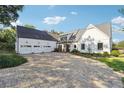 Expansive front yard with circular driveway, white farmhouse exterior, and three-car garage at 3842 Ernest W Barrett Sw Pkwy, Marietta, GA 30064