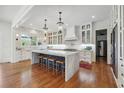Open-concept kitchen with marble island, pendant lighting, stainless appliances, and hardwood floors at 3842 Ernest W Barrett Sw Pkwy, Marietta, GA 30064