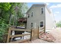 Exterior view of the rear of a home with deck, wood fence and patio with grill at 428 Redwood Trl, Canton, GA 30114