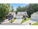 Street view showcasing the home, its two-car garage, manicured landscaping, and inviting front porch at 428 Redwood Trl, Canton, GA 30114