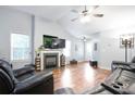 Bright living room with a fireplace, ceiling fan, and hardwood floors with high ceilings at 428 Redwood Trl, Canton, GA 30114