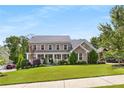 Charming two-story brick home with manicured lawn and inviting front porch at 129 Millstone Way, Canton, GA 30115