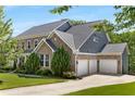 Lovely brick home with three-car garage and well-maintained landscaping at 129 Millstone Way, Canton, GA 30115