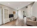 Bright living room featuring hardwood floors, a vaulted ceiling, and access to other rooms at 2657 Albion Farm Way, Duluth, GA 30097