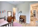 Cozy bedroom featuring hardwood floors, desk, and walk-in closet at 3508 Cox Cemetery Rd, Social Circle, GA 30025