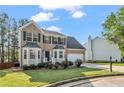 Classic two-story home with a brick front, bay windows, and an attached two-car garage at 3943 Alexandra Oak Ct, Suwanee, GA 30024