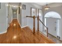Inviting home foyer with gleaming wood floors, a staircase and a welcoming front door with sidelights at 503 Silver Maple Ln, Woodstock, GA 30189