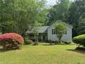 Cozy home with beautiful landscaping, green lawn and mature trees at 861 Creek Trail Nw, Kennesaw, GA 30144